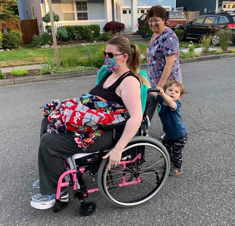 Kristy Novillo is pushed in her wheelchair by Dominic as their family nanny accompanies them on an evening stroll. (Photo courtesy of Jorge Novillo)